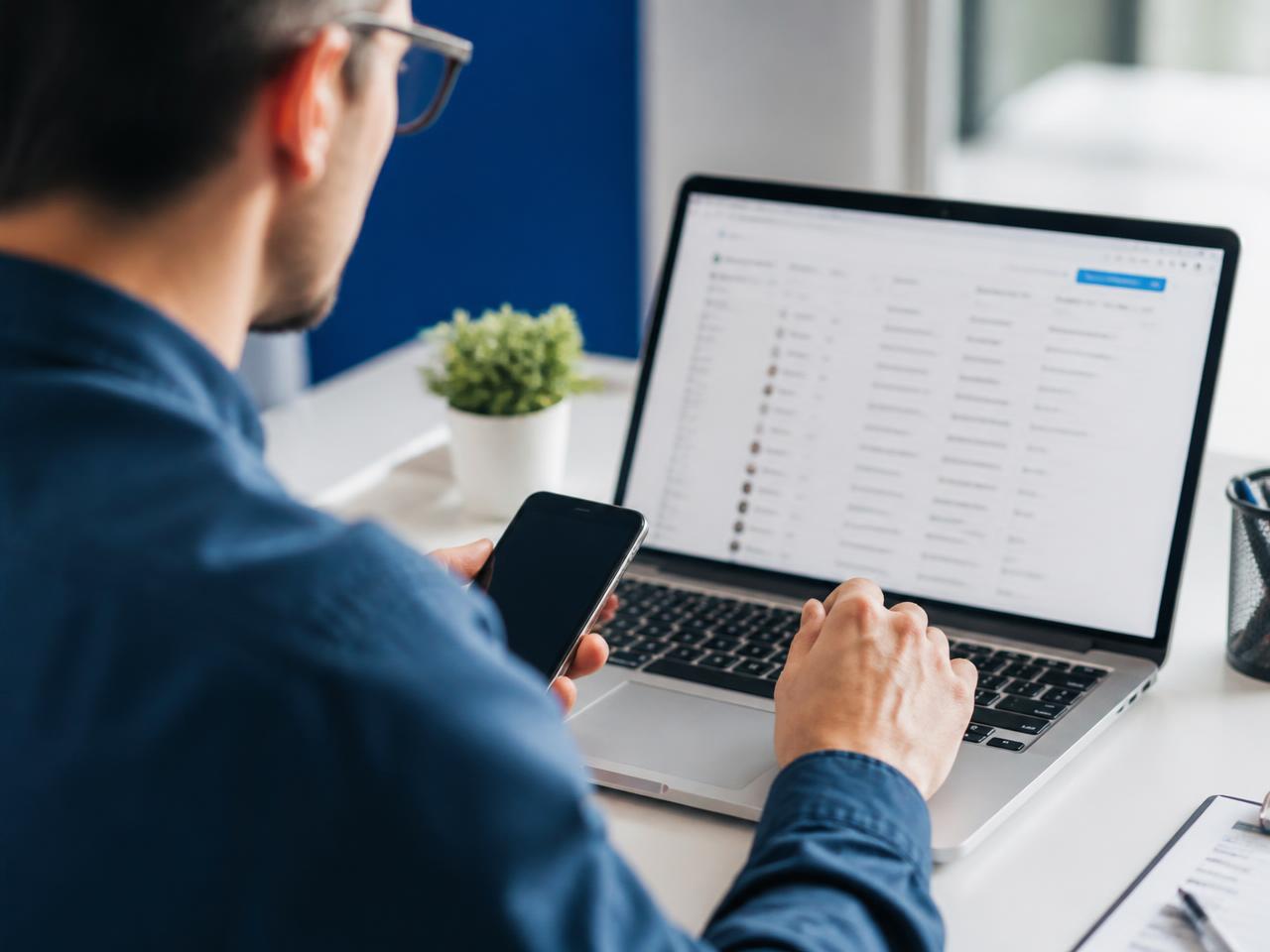 An agency owner reviewing an AI-built prospect list on a laptop
